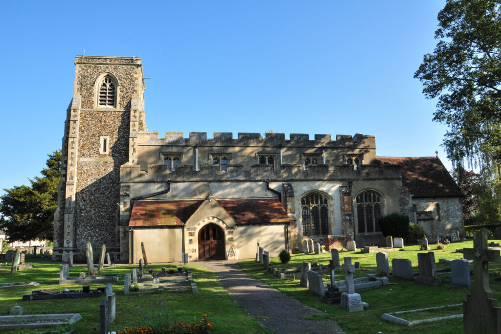 A photo showing a church within the village of Arlesey.